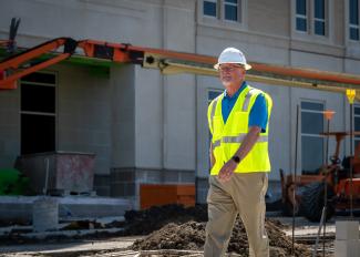John Brewer of Acme Brick walking around construction site